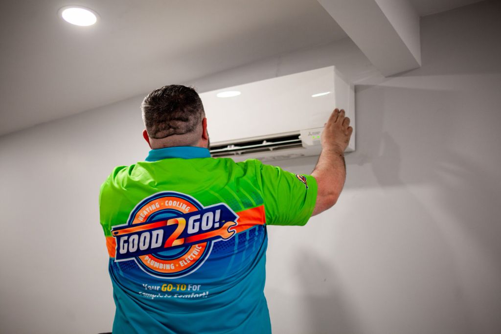 Good 2 Go technician installing a Mitsubishi mini-split indoor unit